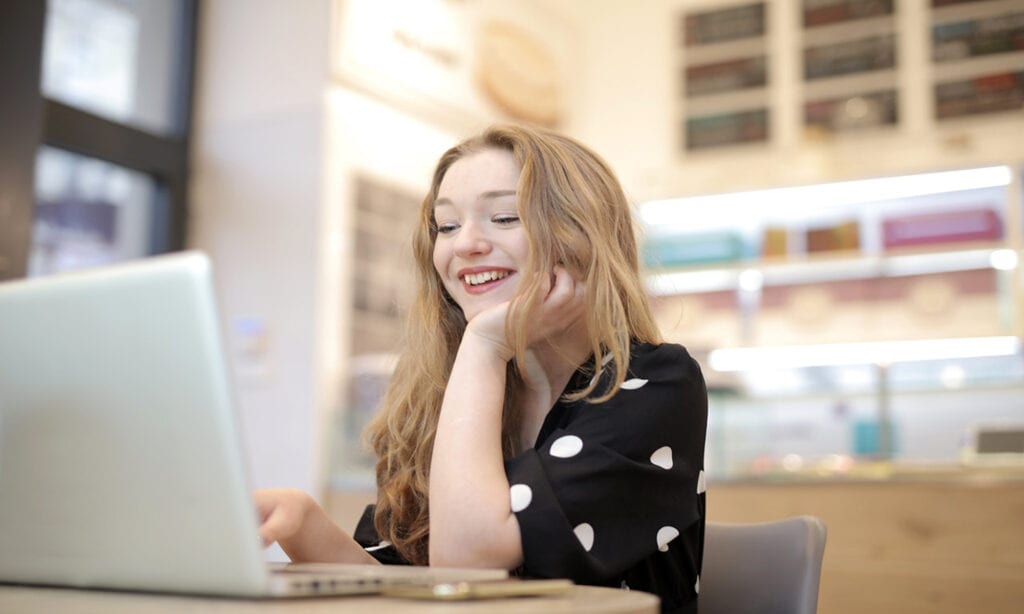 Woman on computer smiling